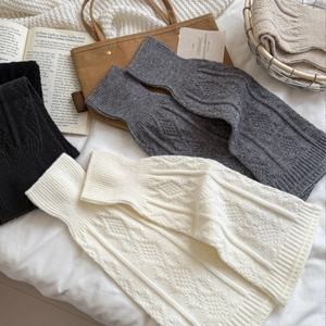 White and grey knitted ballet leg warmers with cable knit texture and ribbed cuffs