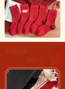 Close-up of red New Year cotton socks with intricate embroidery and patchwork design