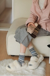 Close-up of Nordic Fair Isle knit wool socks with vintage geometric diamond patterns