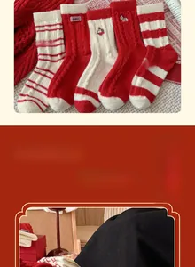Detail of red and white New Year thermal socks with cute embroidery and striped patterns