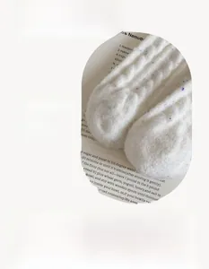 Close-up of white knit thermal socks featuring seamless toe design and colorful flecks