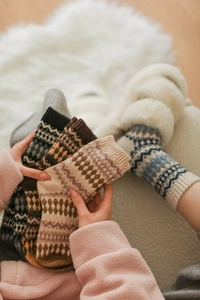 Close-up of Fair Isle argyle pattern wool socks with thick knitted texture in earthy tones