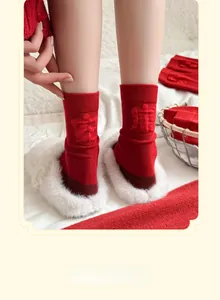 Detail of red Year of the Horse socks featuring 3D embossed Chinese lucky characters