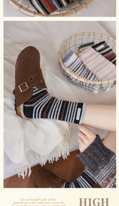 Detail of wool blend striped socks with woven label inside cozy home setting