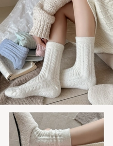 Close-up of thick cable knit texture on warm winter socks in soft pastel colors