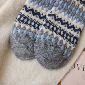 Close-up of Fair Isle geometric knit pattern on thick wool socks with soft texture