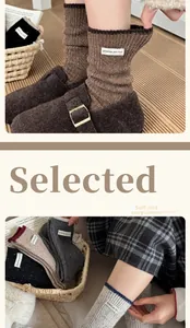 Detailed close-up of thick wool socks with woven label and textured knit pattern