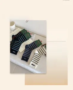 Detail of three pairs of vintage striped cotton socks with stitched handmade fabric labels