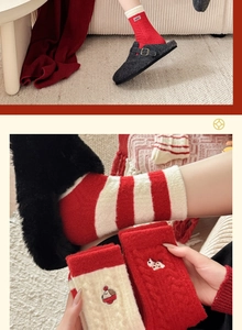 Close-up of festive red knitted socks with cute animal embroidery and striped patterns