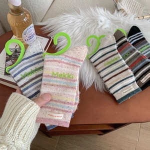 Thick striped wool blend crew socks in colorful patterns for winter warmth and comfort