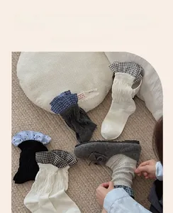 Detail of sweet cotton crew socks featuring contrast ruffle lace cuffs on beige carpet