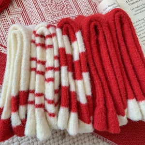 Thick warm red and white Christmas socks in soft cashmere-like knit for winter holiday