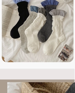 Detail of ribbed knit socks with plaid ruffle cuffs in neutral tones for autumn