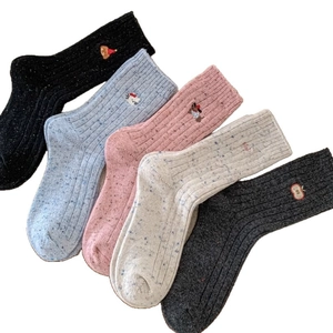 Five pairs of assorted speckled wool blend socks for women in soft cream and neutral tones