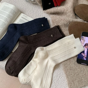 Chic knit wool socks in navy, brown, and cream with metal bear charms and ribbed texture
