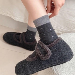 Winter floral wool socks with dark grey plush Mary Jane slippers in cozy home setting