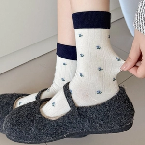 Winter wool socks with floral pattern and high elasticity shown in plush shoes