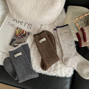 Thick wool blend thermal socks in dark gray and brown with woven luck label