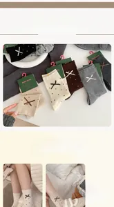 Detail showing knitted wool socks with polka dots and bow embroidery in autumn colors