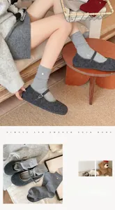 Detail of gray wool socks with silver buckle paired with plush Mary Jane flats