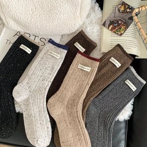 Five pairs of thick wool socks in autumn colors with woven Wishing you luck label