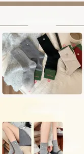 Detailed close-up of wool socks with silver buckle tag and branded paper packaging
