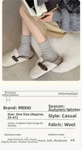 Detail view of light gray wool crew socks featuring thick ribbed texture for winter warmth