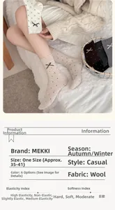 Detail of wool mid-calf socks with red polka dots and beige base for women in winter