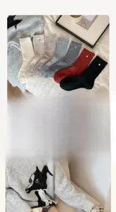 Close-up of wool-blend mid-calf socks set with unique silver button detail in various colors