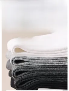 Detailed stack of black, white, and grey cotton crew socks featuring 10A antibacterial fabric