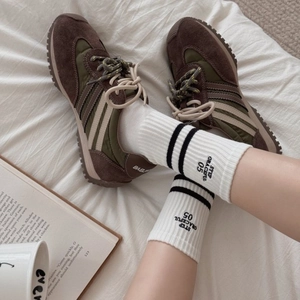 Striped cotton crew socks with athletic letter embroidery paired with retro sneakers
