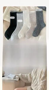Detail of five-pair wool sock set in neutral colors with ribbed cuffs and cozy texture