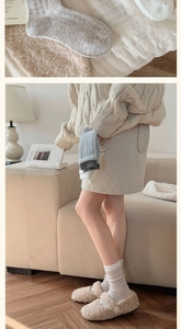 Detail of warm wool blend socks featuring vertical knit texture and soft Morandi colors