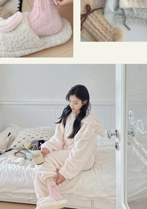 Detail of pink bow mink velvet socks paired with plush home wear and slippers