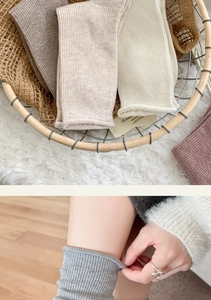 Detailed texture of rib-knit slouch socks in neutral tones for autumn and winter