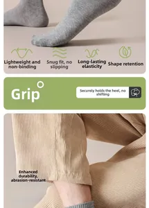 Detail of grey cotton crew socks featuring reinforced heels and non-slip ribbed cuffs