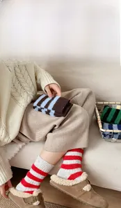 Detail of cozy striped wool socks with plush texture and warm contrasting color cuffs