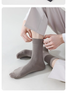 Detail of grey crew socks featuring breathable ribbed texture and premium cotton material