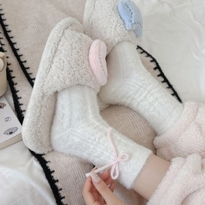 Sweet winter home set featuring plush slippers and matching fuzzy socks with pink bows