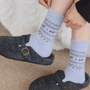 Winter Fair Isle knit socks in light blue with Nordic patterns paired with cozy home slippers