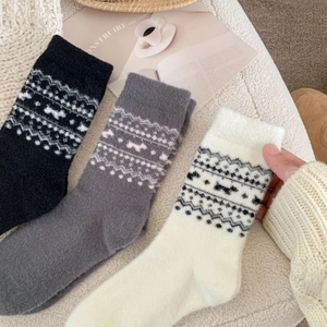 Three pairs of warm Nordic knit socks in black and grey with geometric patterns