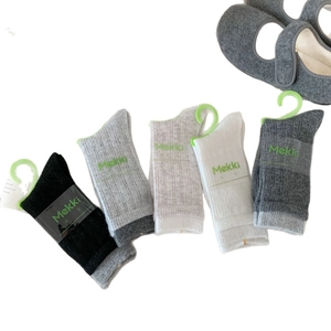 Five pairs of ribbed wool socks for women in black, grey, and white with elastic cuffs