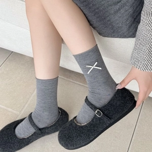 Women's gray wool blend crew socks with white cross embroidery and Mary Jane shoes
