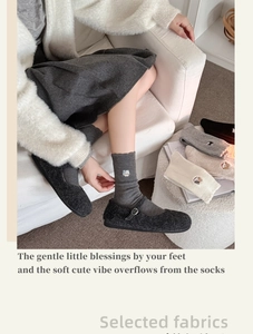 Close-up of winter faux wool socks featuring cute animal embroidery and ribbed texture