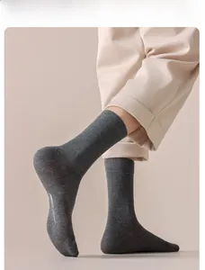 Detail of dark grey crew cotton socks with high-density knitting and soft texture