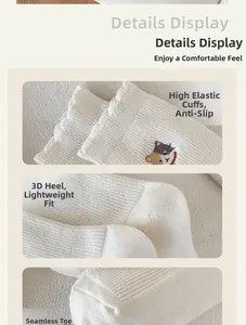 Detail display of white cotton socks featuring high elastic cuffs and cat embroidery