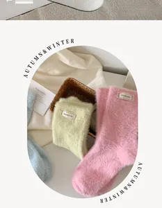 Detailed macro view of macaron-colored fuzzy mink velvet socks with handmade fabric labels