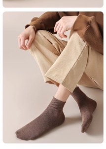 Close-up of deep brown cotton knit mid-calf socks with high-quality ribbed texture