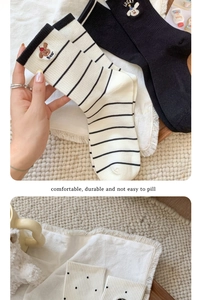 Detail of cotton crew socks featuring cute cartoon bear and puppy embroidery accents