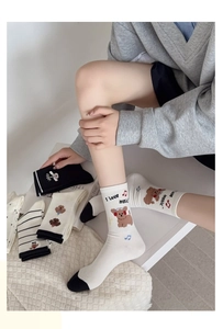 Detail of assorted crew socks with cute bear embroidery and stylish stripe patterns